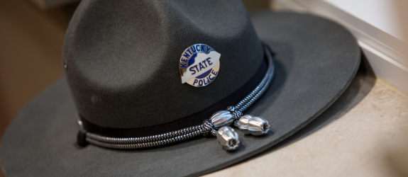 A Kentucky State Police hat rests on a windowsill.