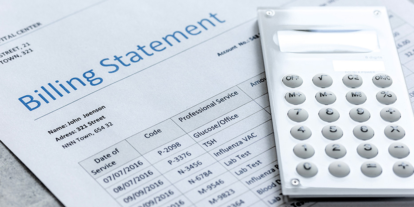 Photo of a medical billing statement and a calculator.
