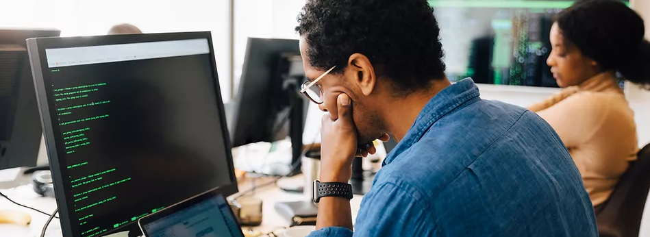 A man works at a computer.