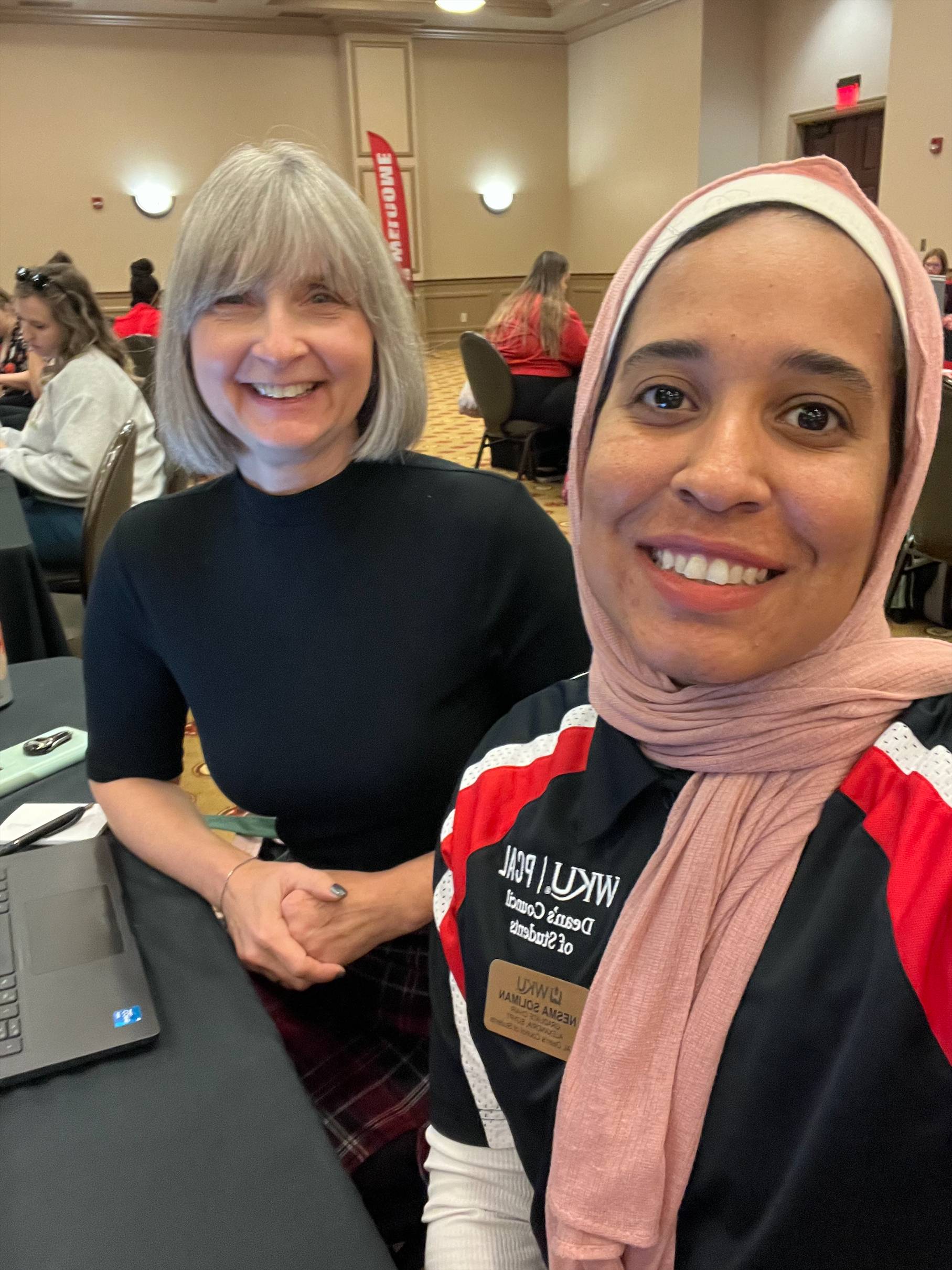 Professor and student at a conference