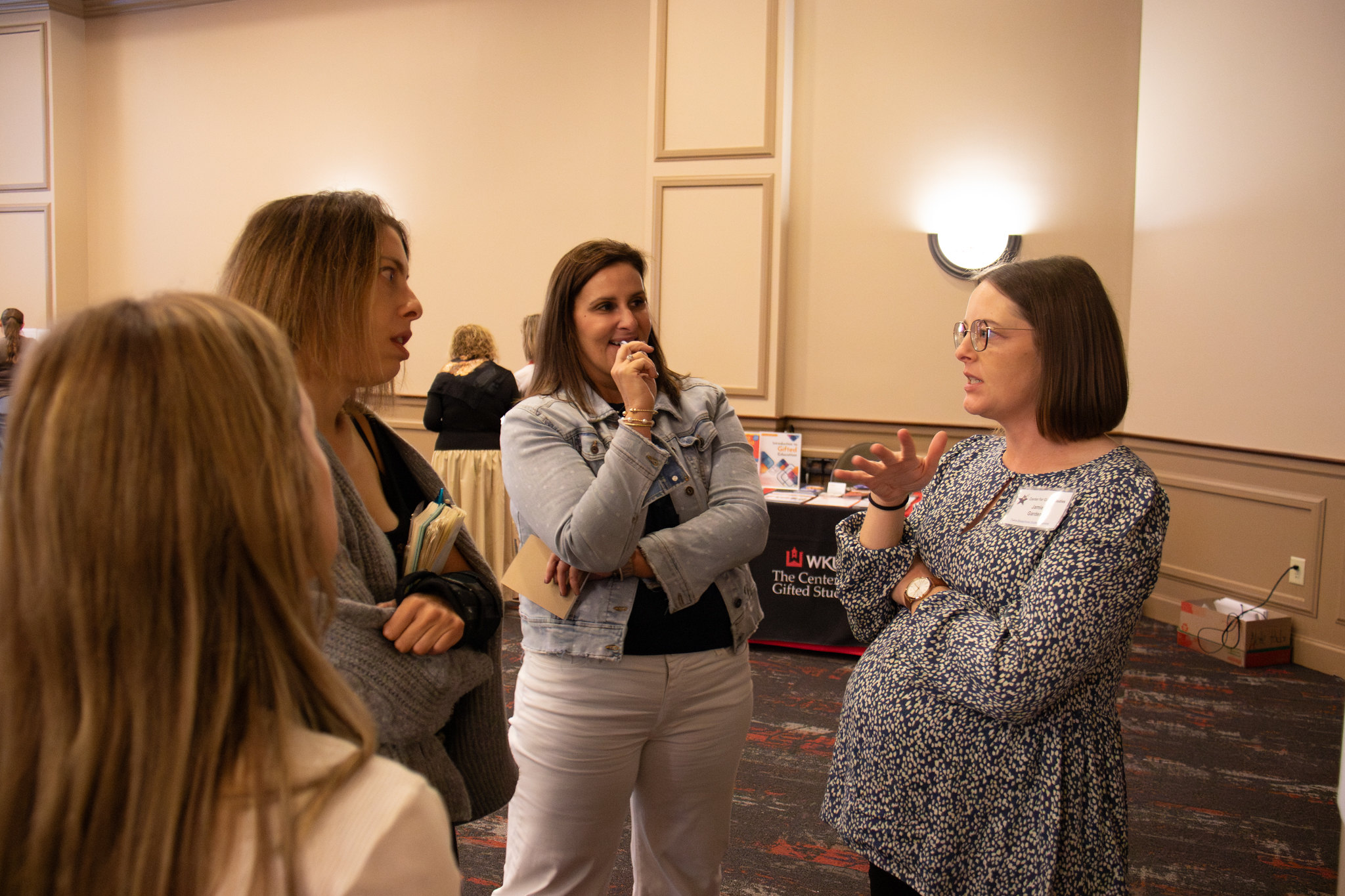 image of three women speaking to one another