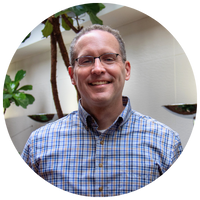 image of man wearing a blue plaid shirt