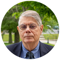 man wearing tinted glasses and blue blazer