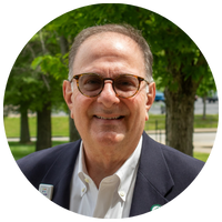 image of man wearing tinted glasses and blue blazer