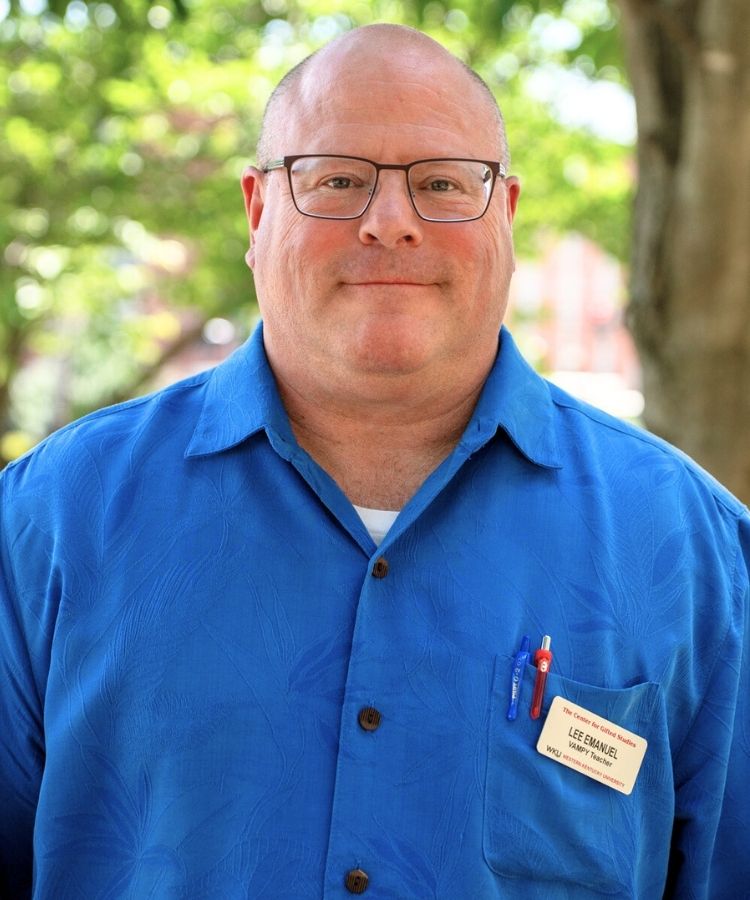 man in blue shirt smiling at the camera