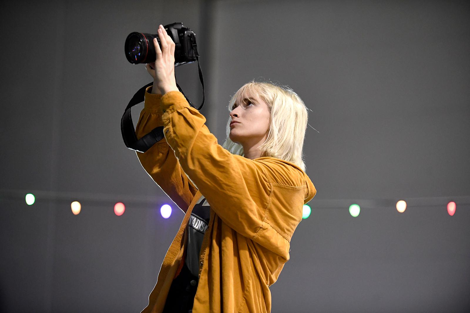 student with camera