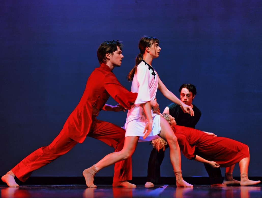 Dancers working together on stage.